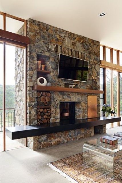 chic texture and bold earthy colors make this fireplace amazing, and a black mantel and firewood storage is awesome