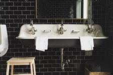 10 glossy black subway tiles for a masculine art deco bathroom and brass touches to make it chic