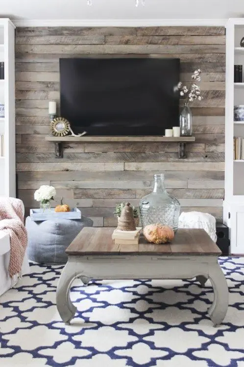 a cozy space with a rustic reclaimed wooden wall and a coffee table that matches