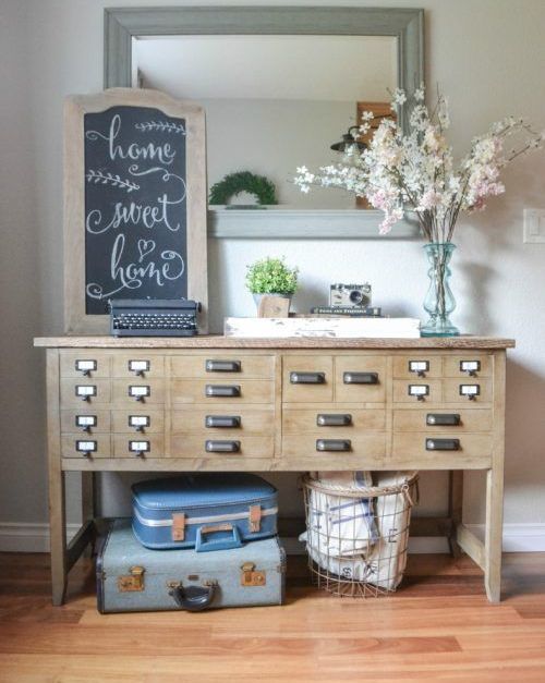 an apothecary cabinet turned into an eye-catchy console table for an entryway