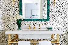 11 eye-catchy Dalmatian print wallpaper, a malachite mirror frame and brass accents for an eye-catchy look