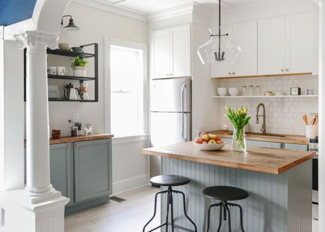 lower dove grey cabinets and white uppers with natural wood countertops for a cozy natural feel