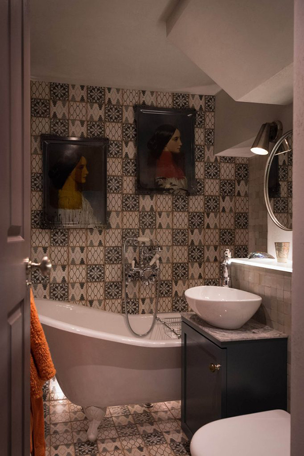The second bathroom is clad with mosaic tiles and there portraits to make it artistic