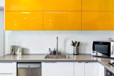 12 a minimalist yellow and white kitchen with stainless steel appliances and countertops and a subway tile backsplash