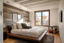 12 a modern bedroom with a reclaimed wooden wall and a wood floating platform bed