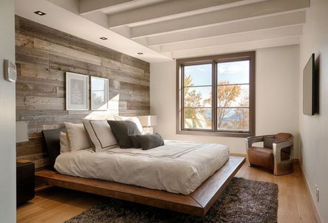 a modern bedroom with a reclaimed wooden wall and a wood floating platform bed