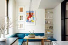 12 a modern bench with storage space and bold teal upholstery for a dining nook