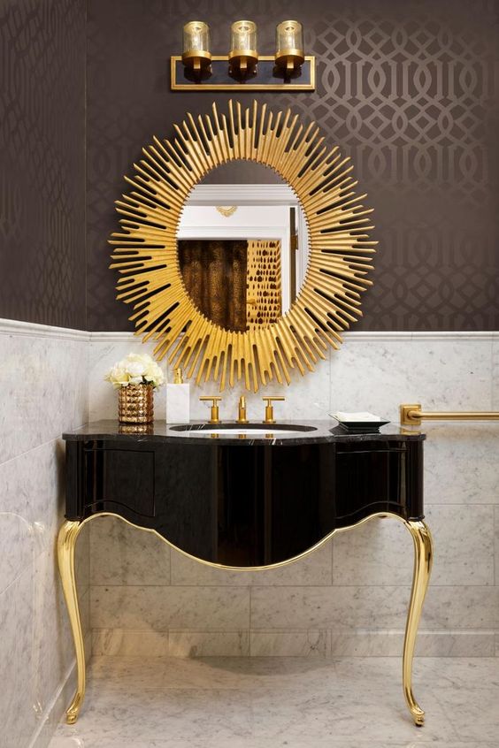 a refined black and gold bathroom vanity and a sunburst mirror is a great idea for a refined art deco space