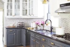 12 a vintage-styled kitchen with white and grey cabinets, brass touches and a black countertop