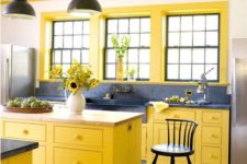 14 a farmhouse yellow and grey kitchen with a vintage feel, grey marble counters and vintage lamps