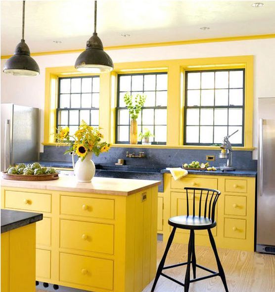 a farmhouse yellow and grey kitchen with a vintage feel, grey marble counters and vintage lamps
