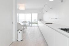 14 a large long minimalist white kitchen with only floor cabinets and whitewashed floors