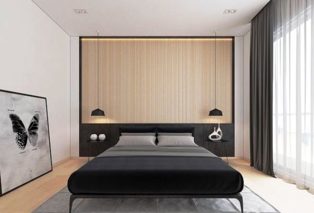 A light colored wood slat headboard wall and a black bed, black pendant lamps and curtains