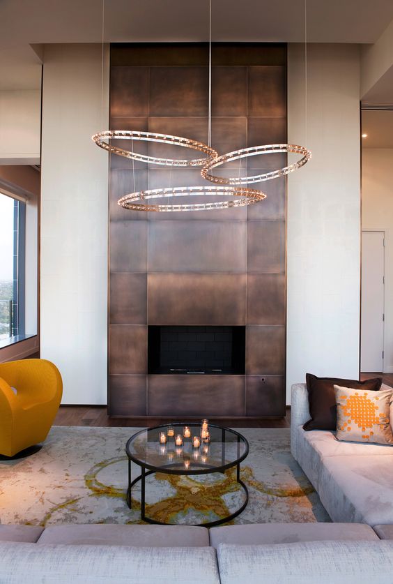 a modern fireplace clad with darkened copper looks really wow and impressive