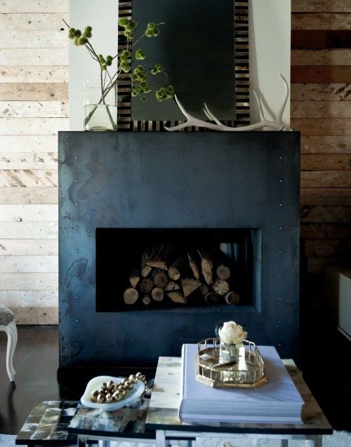 a fireplace clad with metal sheets is a great feature for industrial and masculine spaces