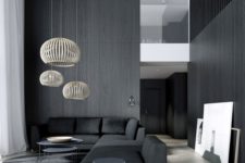 15 a minimalist space with black wooden walls and furniture, cool pendant lamps highlight the double height ceiling