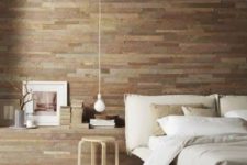 15 a modern bedroom is made cozier and more welcoming with a reclaimed wooden wall, whitewashed floor and wooden furniture