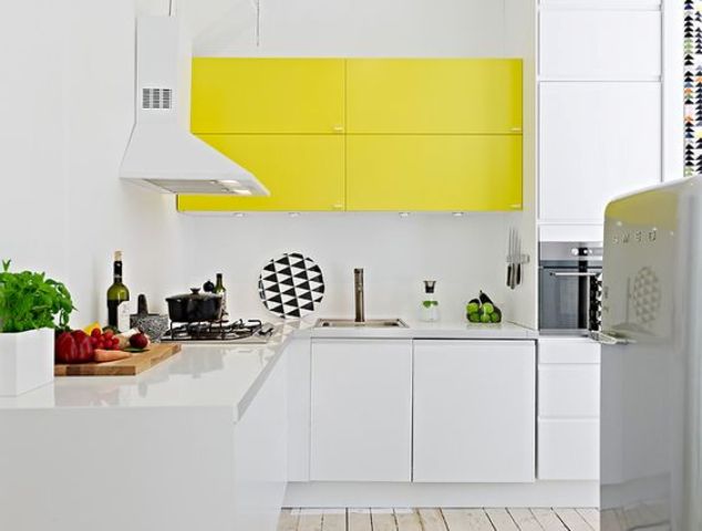 a white kitchen with a suspended lemon yellow cabinet to add a colorful touch and to make the kitchen vivacious