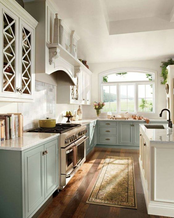 pastel blue and white ktichen in vintage farmhouse style, with a white kitchen island
