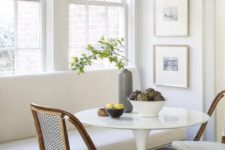 16 a classic white bench and wicker chairs that make up a cool and cozy breakfast nook