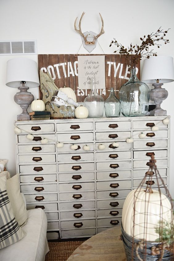 a neutral apothecary cabinet as a living room console table with lots of storage