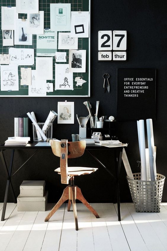 a stylish manly office with a masculine feel and a black statement wall and whitewashed floors