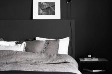 17 a Scandinavian masculine bedroom with a black wall, bed and bedding looks inviting and relaxing