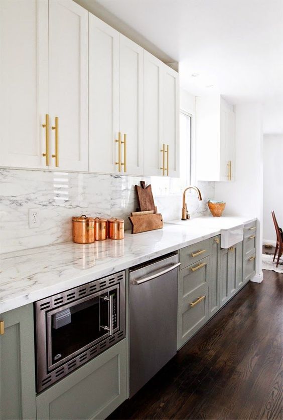 a farmhouse kitchen with dove grey and whiet cabinets, brass and copper touches for a cool glam feel