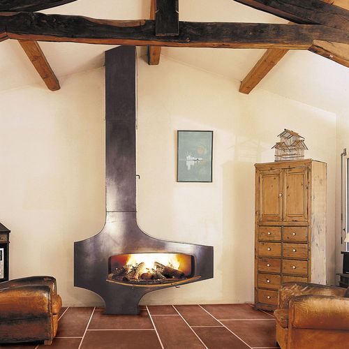 a vintage rustic space with a gorgeous wood burning fireplace with metal covers