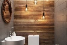 17 a wood accent wall and lots of industrial geo bulbs hanging over the toilet