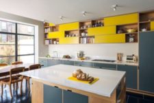 17 navy and yellow kitchen cabinets with a neutral backsplash and counters look contrasting and chic