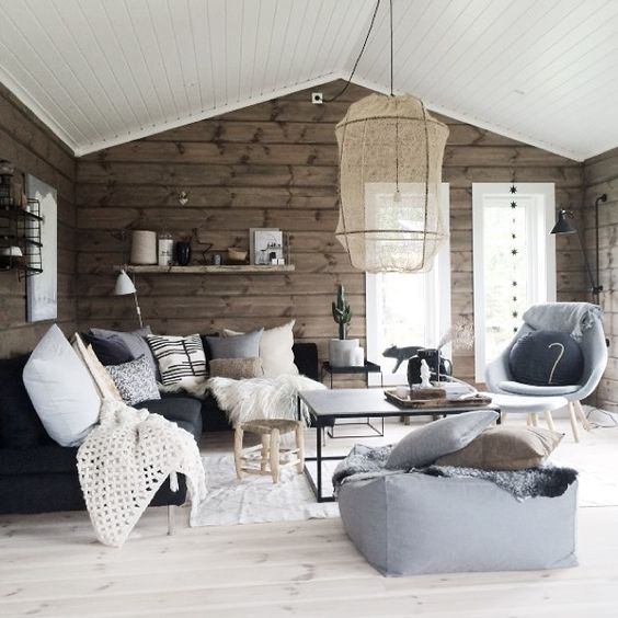 A Scandinavian space is made warmer and cozier with wooden walls in a natural finish