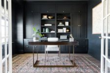 18 a chic home office space with black walls, and one wall taken with cabinets and shelving, lots of light in