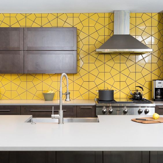 a modern dark kitchen with a whole wall taken by yellow tiles looks very bold and unusual