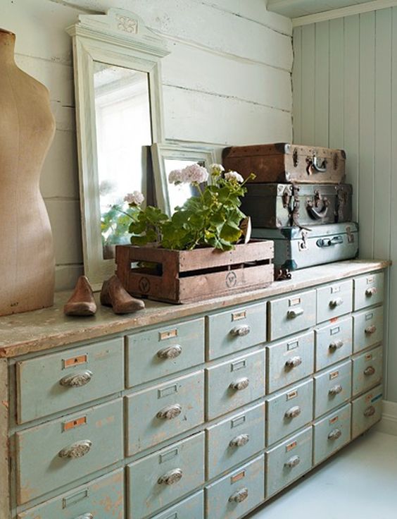 a shabby chic mint colored apothecary cabinet for a soft pastel interior