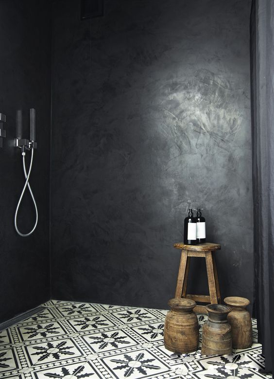 black stone in the shower and mosaic tiles on the floor make the space eye-catching and moody, which is trendy