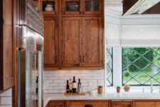 18 stained wooden kitchen cabinets and white countertops look cozy and very chic