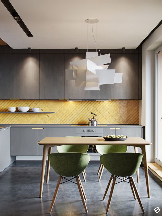 a minimalist moody grey kitchen with a sunny yellow tile backsplash clad in a diagonal way