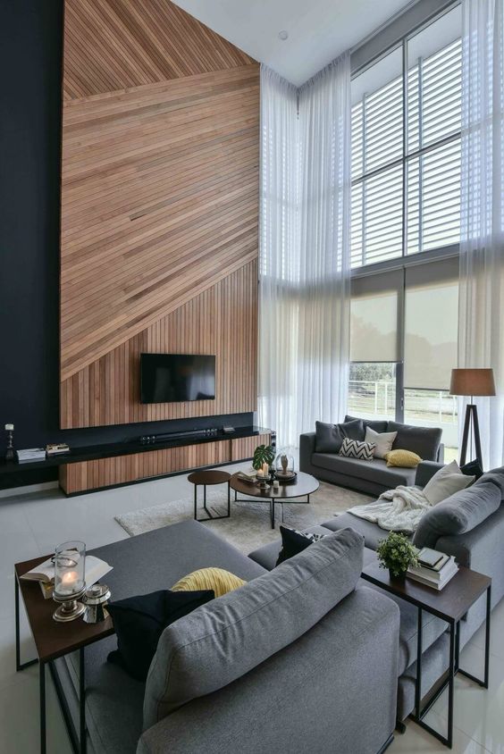 a spectacular double height space with a wooden plank wall clad diagonally and vertically for more eye-catchines