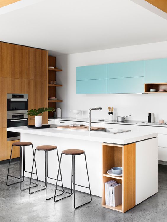 a white and light blue kitchen looks modern and refreshing, and natural wood touches make it cozier