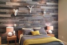 19 add a rustic touch to your space with a reclaimed wooden wall and faux animal heads