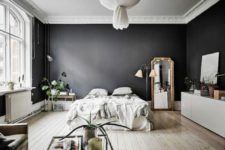20 a dramatic Scandinavian space with black walls looks airy thanks to lots of light and light-colored wooden floors