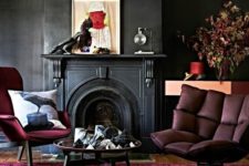 20 a moody space with black walls, a fuchsia rug and furniture and artworks