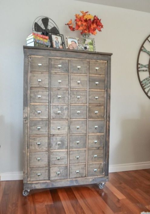 a reclaimed wood apothecary cabinet on casters will be a comfy storage unit for any space