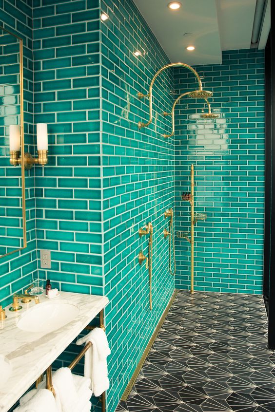 brass fixtures and mosaic tiles on the floor make the space more chic and more eye-catching
