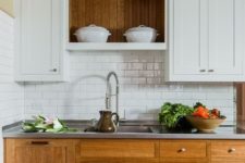 21 a cozy rustic kitchen with white and wooden cabinets of traditional design and a subway tile backsplash