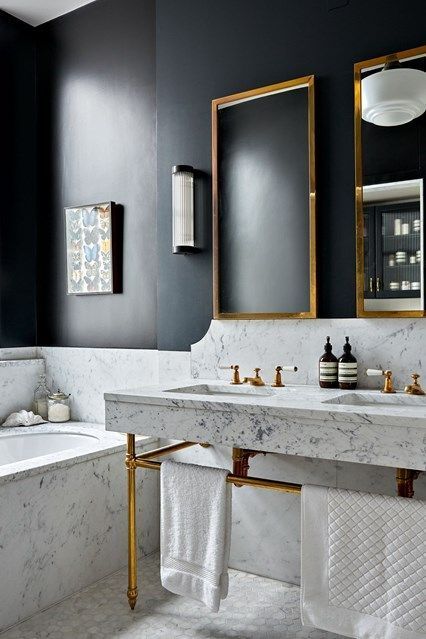 black walls and white marble for a bold modern space, and brass touches to make it more glam
