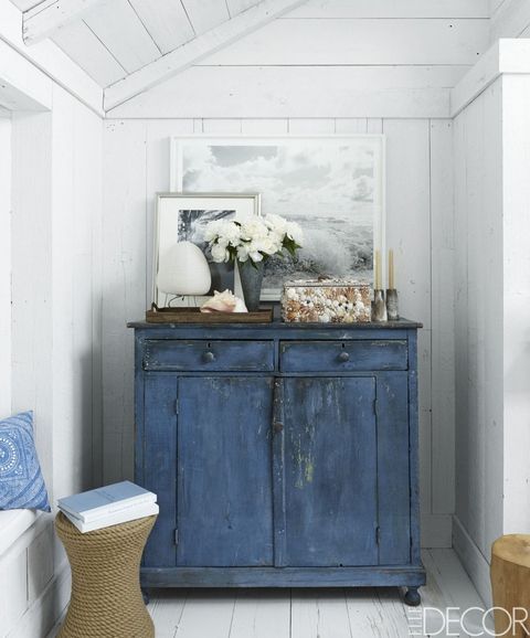a colorful shabby chic cabinet is another great idea for storage in an awkward corner