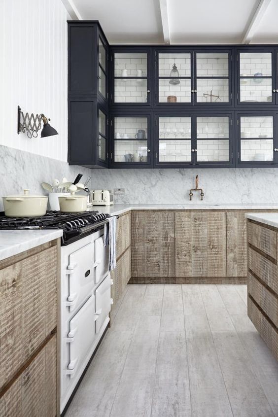 a creative space with black glass cabinets and reclaimed wood lower ones, vintage appliances and subway tiles on the wall