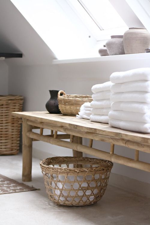 a wooden bench and some baskets for storage will add a spa feel to your bathroom